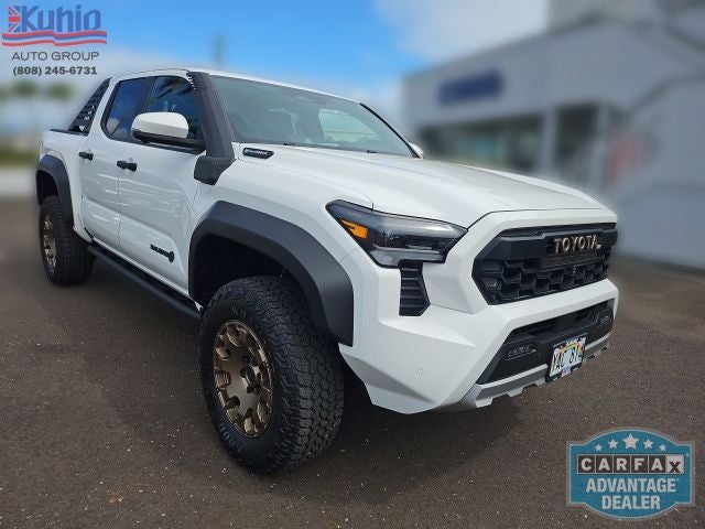 2024 Toyota Tacoma Hybrid Trailhunter in White — front three-quarter view